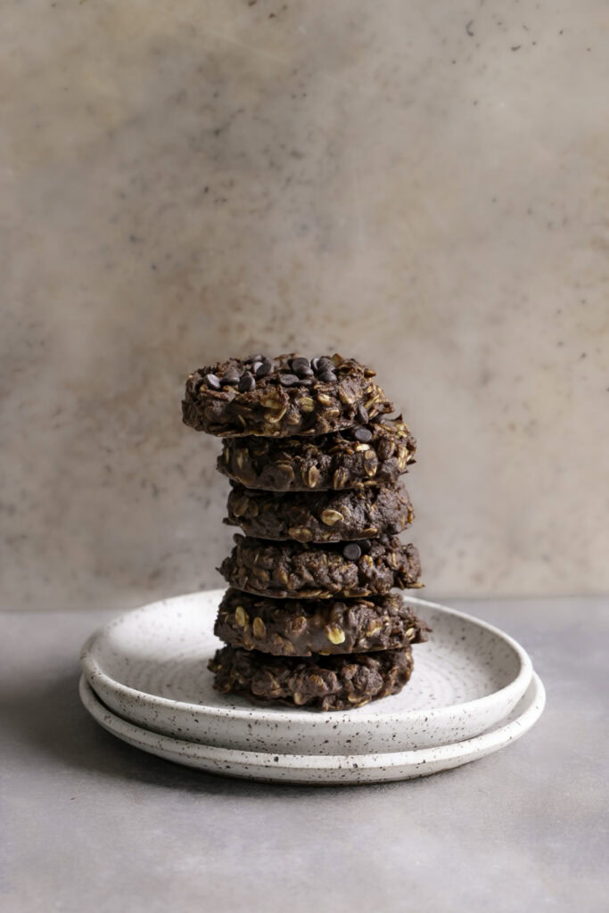 no-bake pumpkin brownie oatmeal cookies stacked on top of one another vertically on a plate