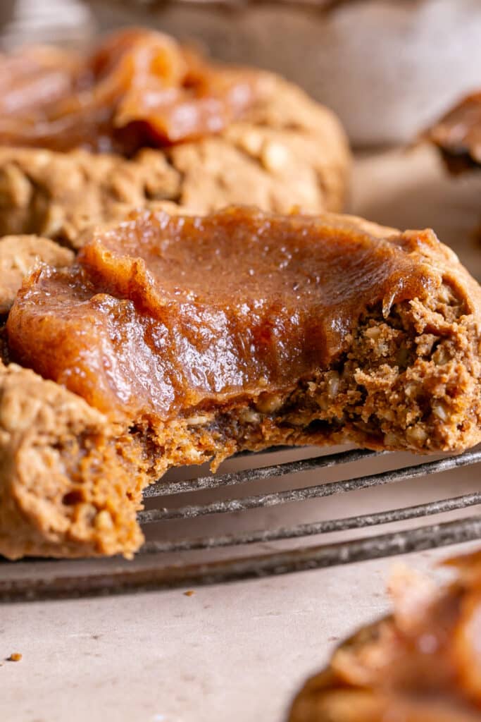 close up of a Pumpkin Spice Oatmeal Thumbprint Cookie with a bite taken out of it