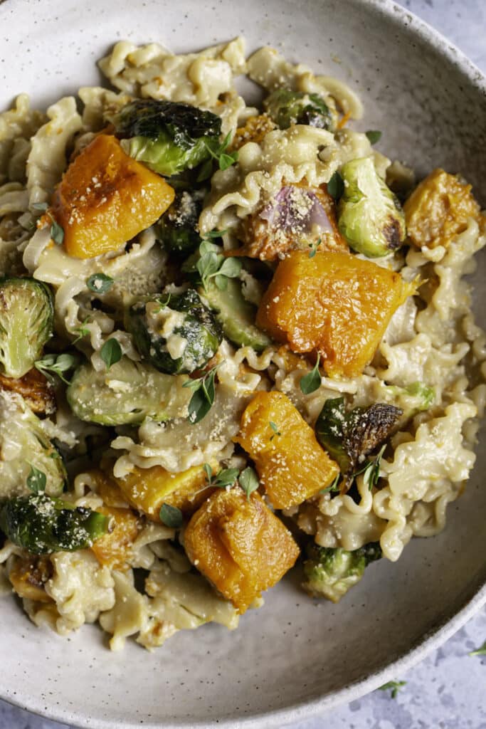 a very a close up of a bowl of Buttery Butternut Squash and Brussels Sprouts Pasta