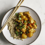 a bowl of 30 Minute Sweet & Sour Tofu with wooden chopsticks resting on the bowl