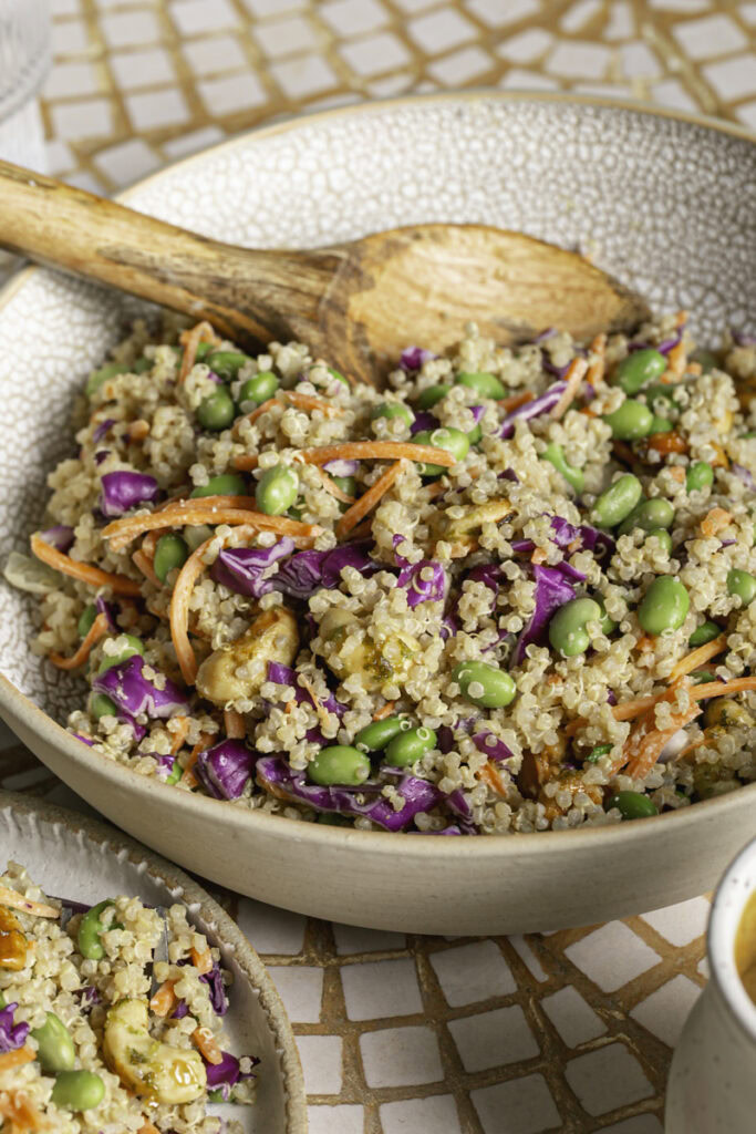 3/4 edamame quinoa salad mixed together in a large bowl.