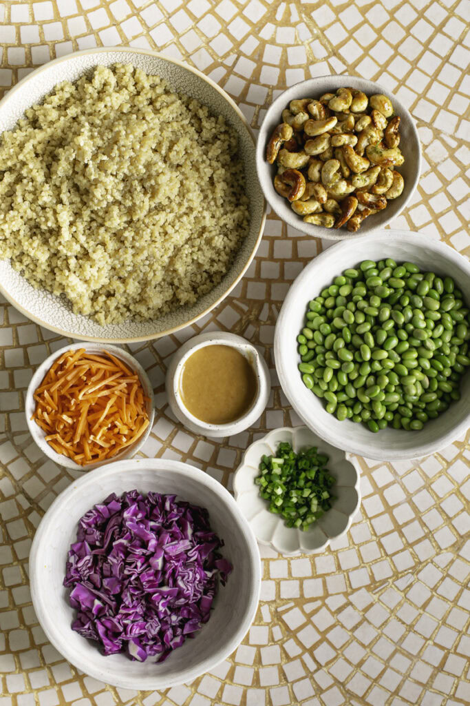 ingredients used to make edamame quinoa salad in separate bowls.