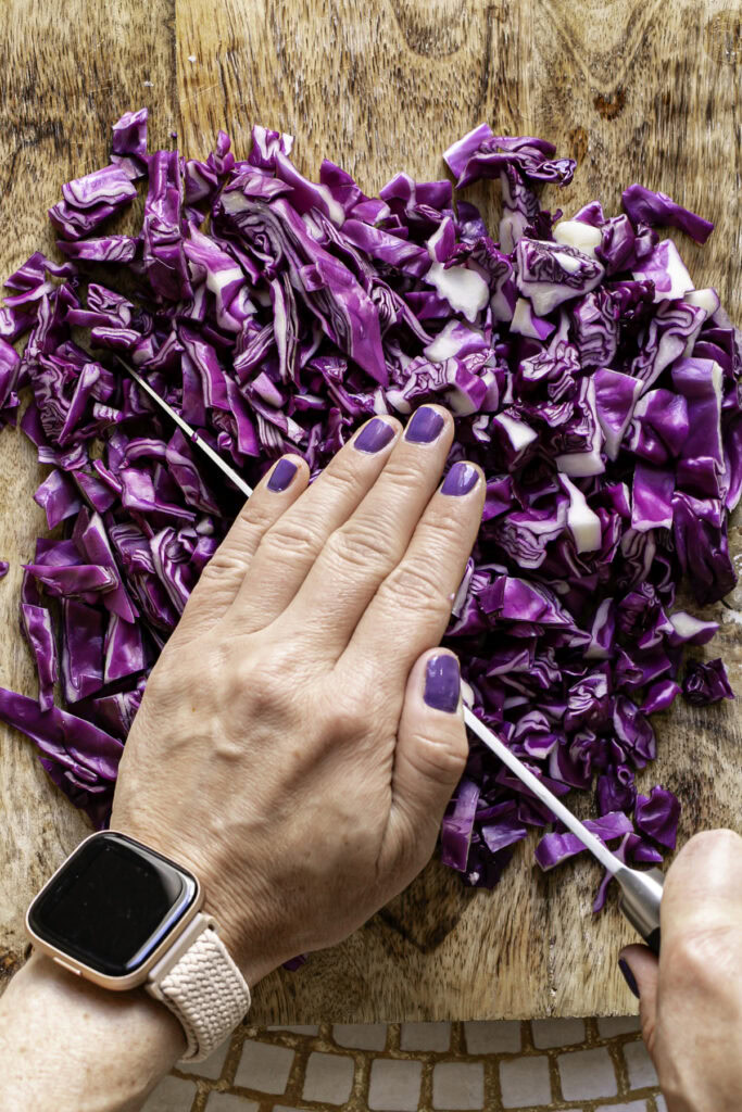 action shot of cutting the red cabbage into small pieces.