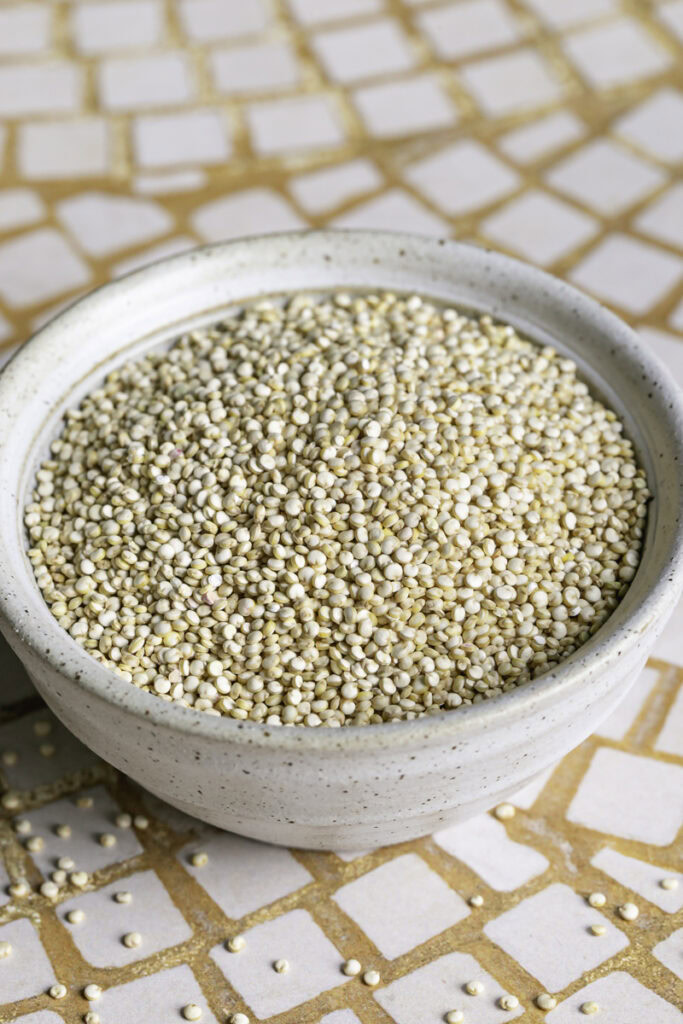dry quinoa in a ceramic bowl.