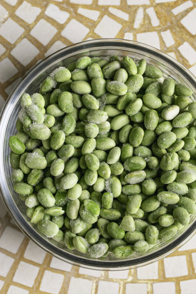 frozen edamame in a glass bowl.