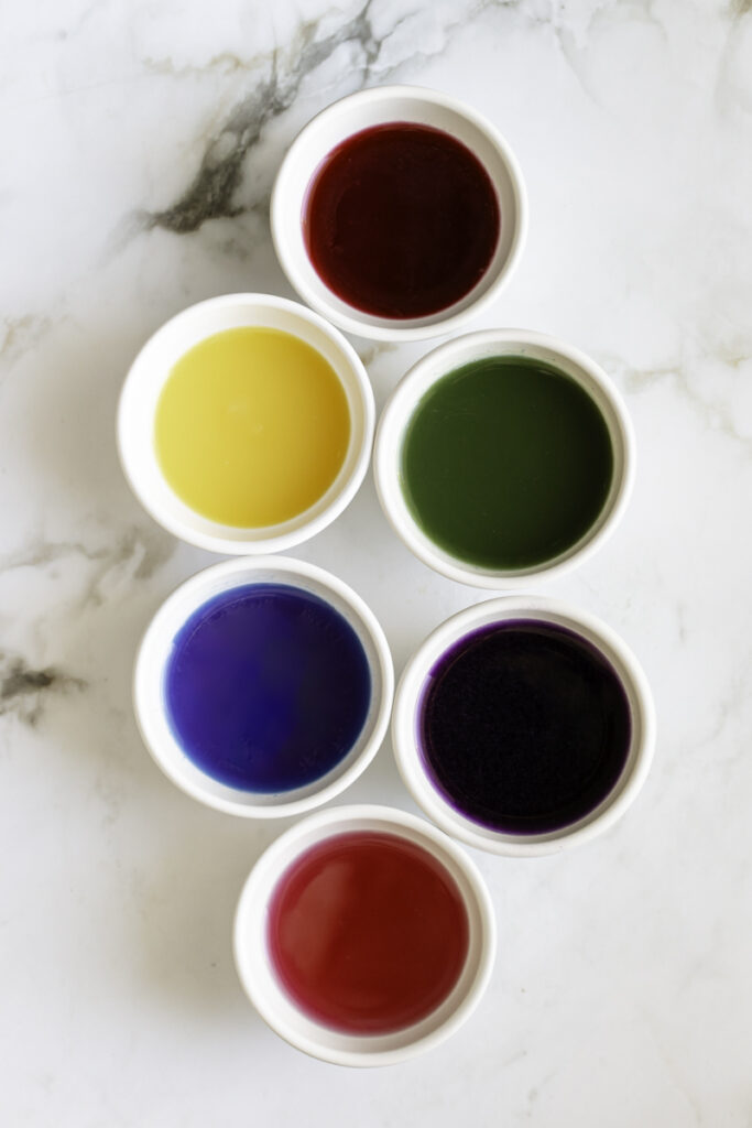6 bowls of liquid food coloring.