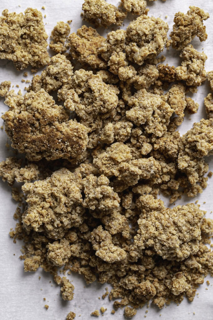 almond flour biscuit crumble on a piece of parchment paper.
