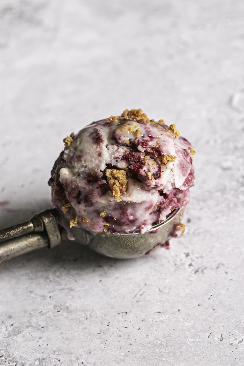 a scoop of blackberry cobbler ice cream in an ice cream scoop.
