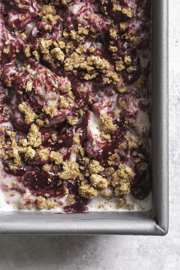 close up overhead shot of blackberry cobbler ice cream in a loaf pan.