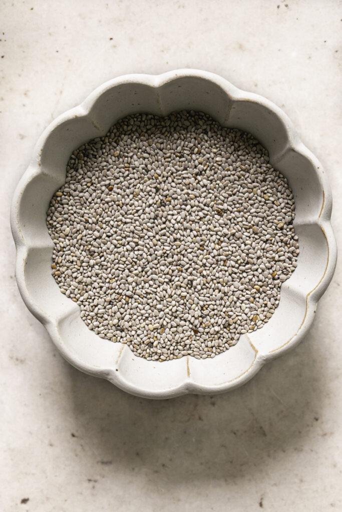 a bowl filled with white chia seeds.
