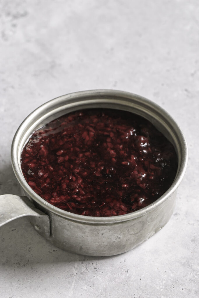 3/4 shot of blackberry curd in a small saucepan.