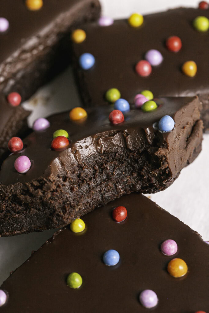 a close up of a cosmic date brownie with a bite taken out of it.