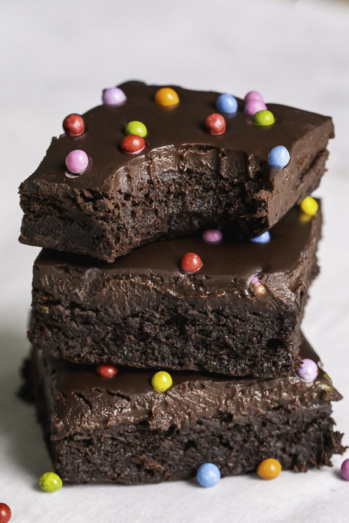 three cosmic brownies stacked on top of one another, the top one with a bite taken out of it.
