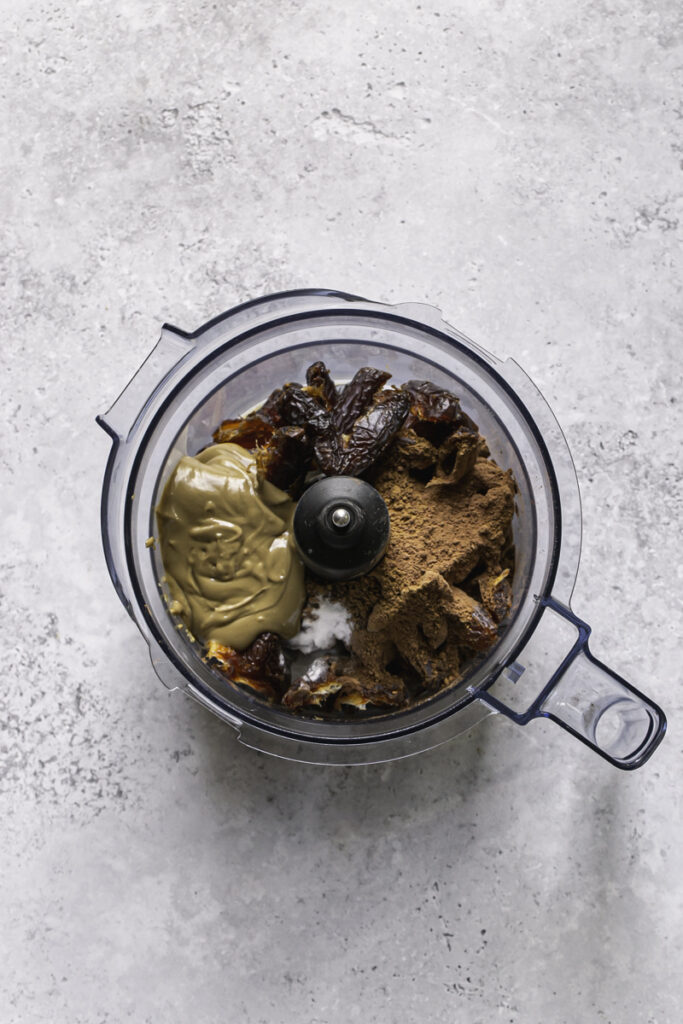 all of the ingredients needed to make date brownies in a food processor.