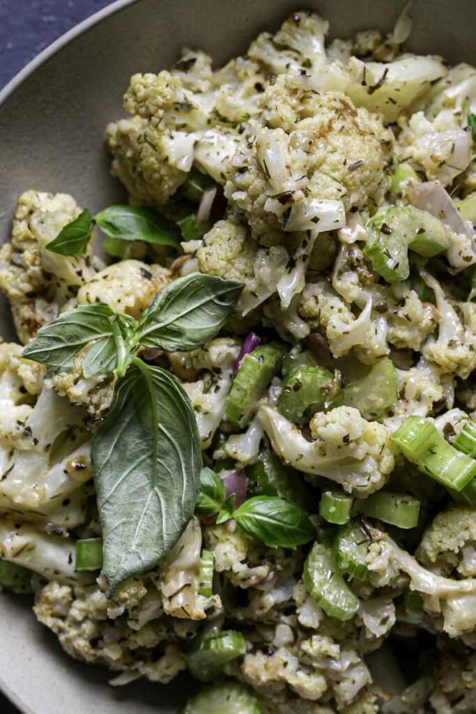 a close up of a bowl of Low Carb Roasted Cauliflower Potato Salad.