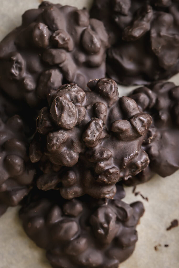 overhead shot of chocolate raisin clusters stacked on top of one another.