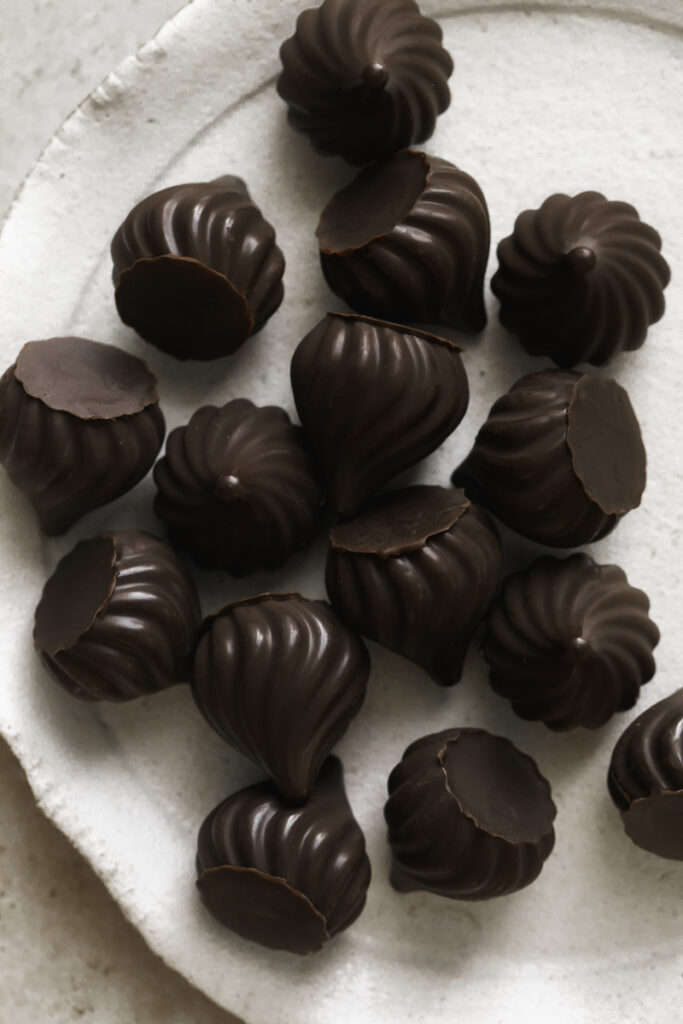 overhead of homemade chocolate kisses on a white plate.