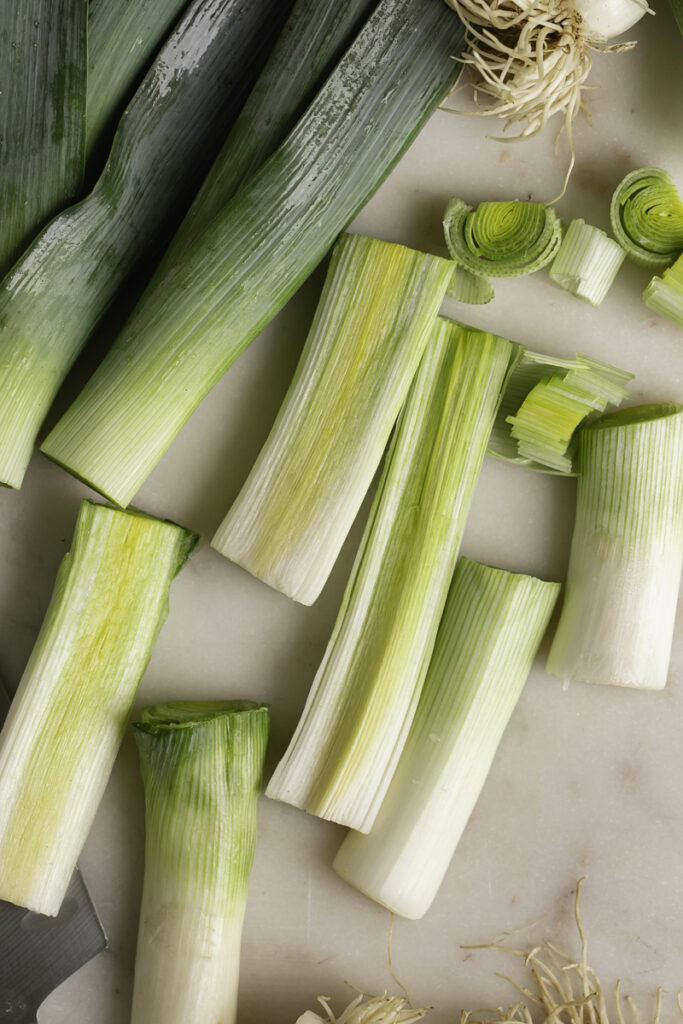 chopped leeks on a marble cutting board.