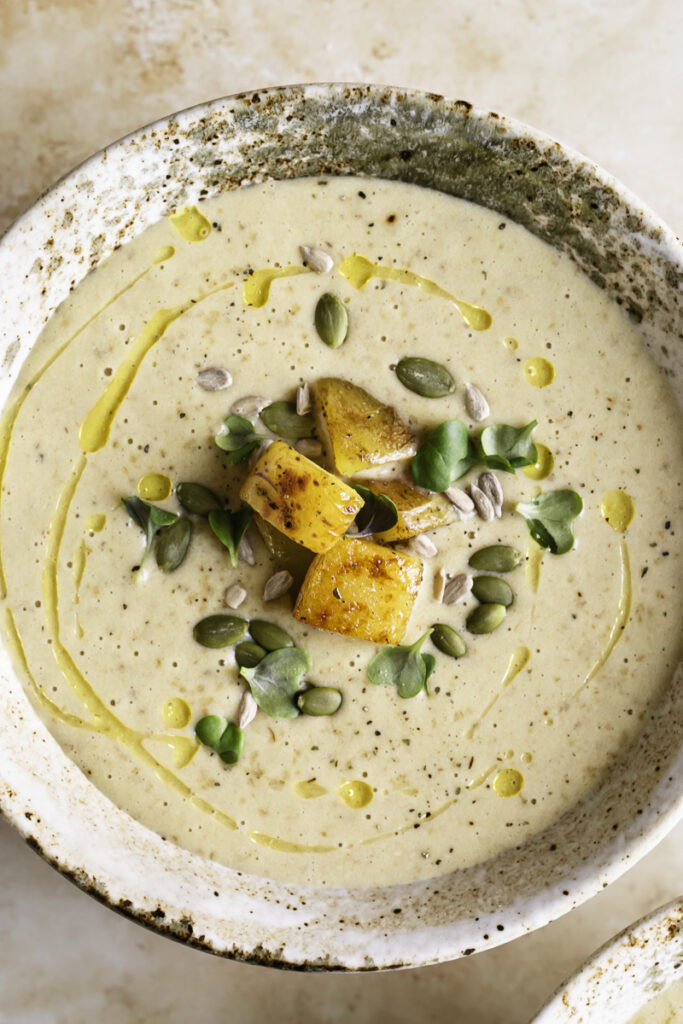 close up overhead shot of a bowl of Creamy Roasted Gold Potato Leek Soup.
