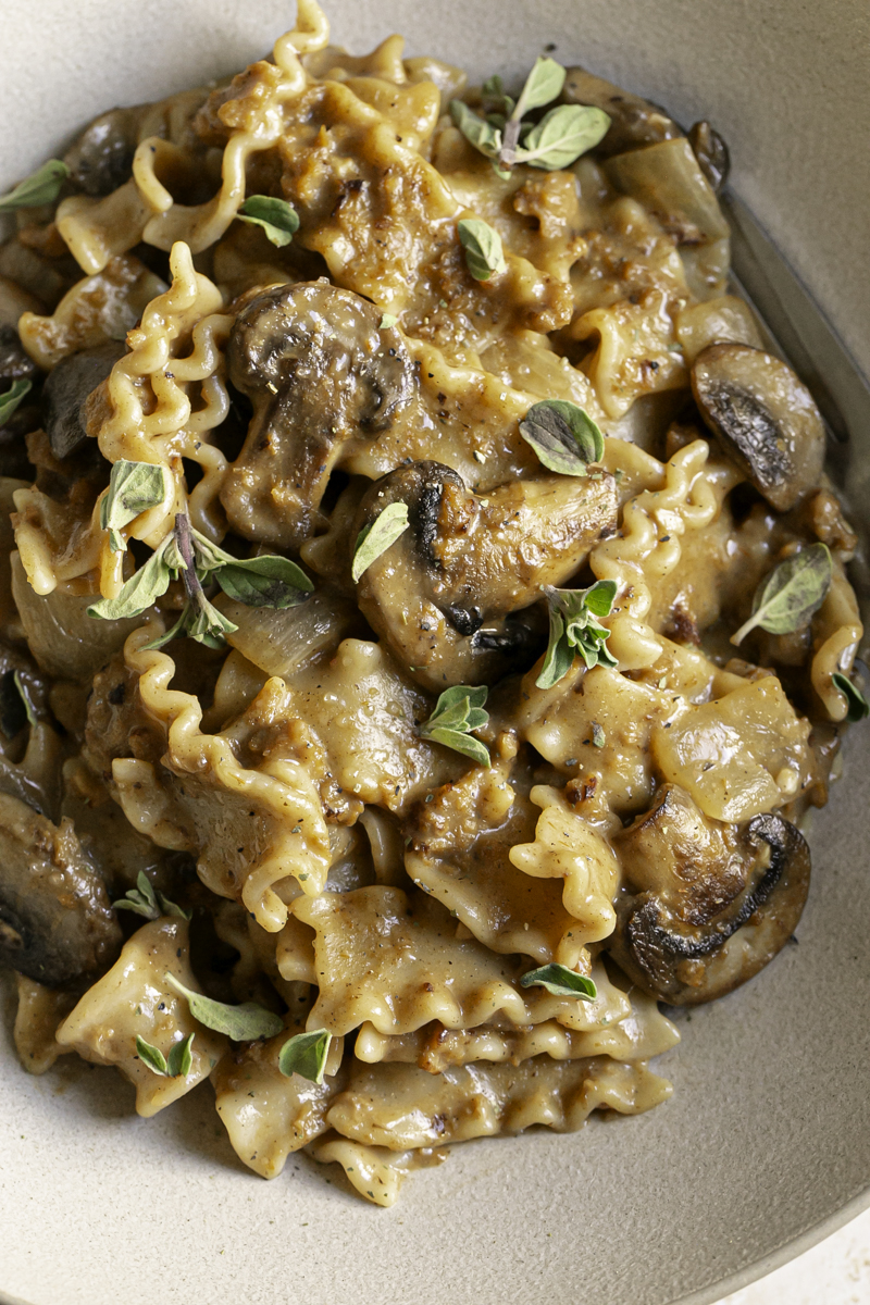 homemade one pan vegan beef stroganoff hamburger helper served in a bowl garnished with fresh oregano.