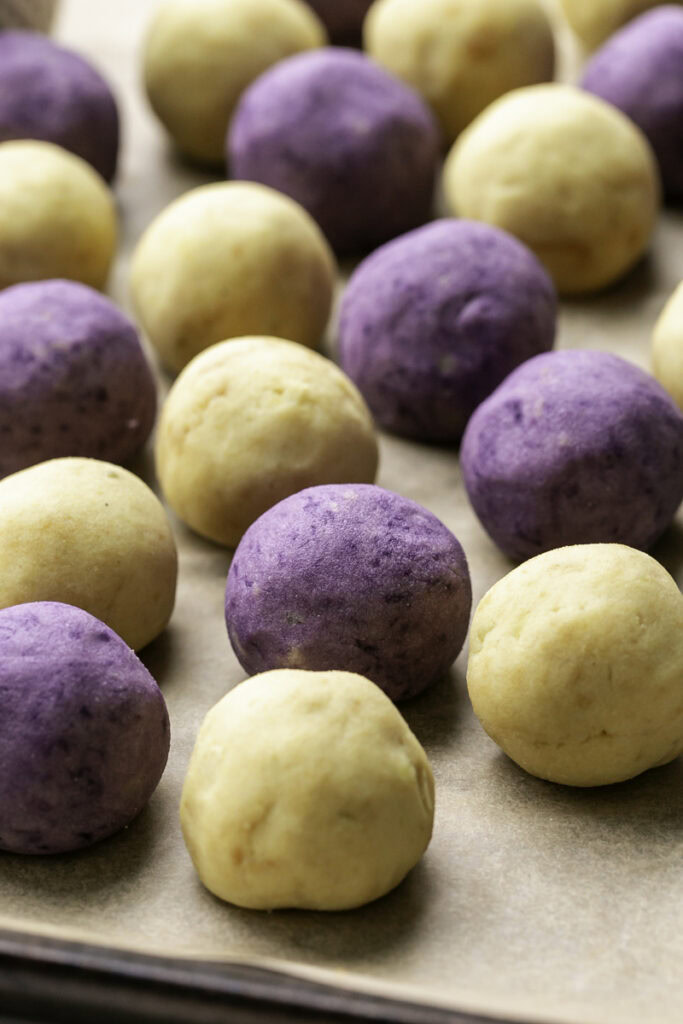 balls of mashed potatoes, some purple, some yellow-orange.