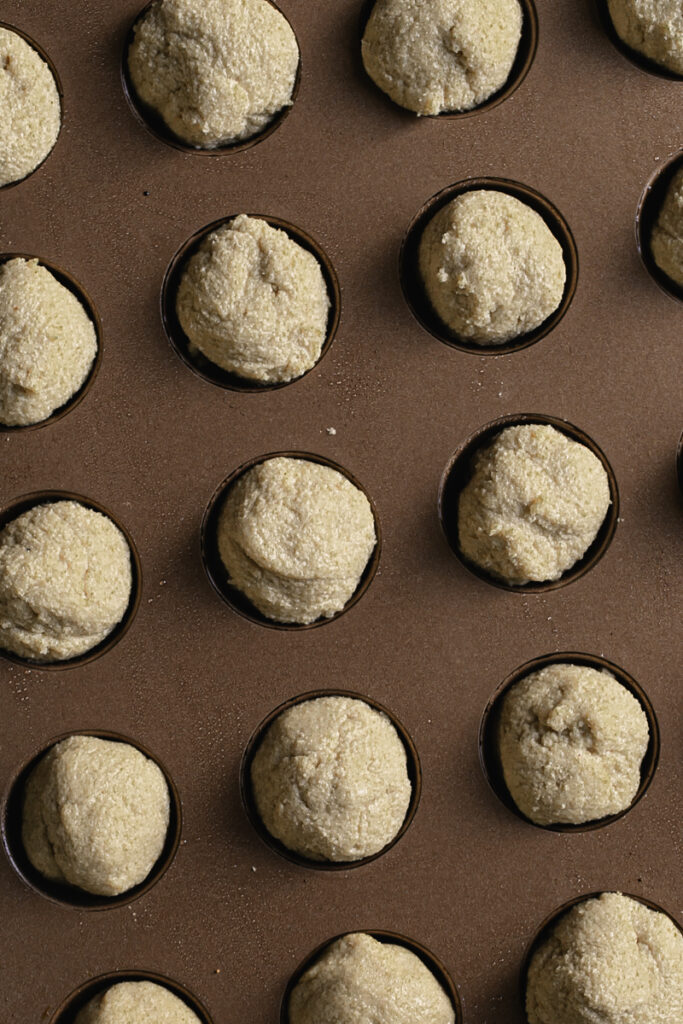 unbaked donut holes in a donut hole baking pan.