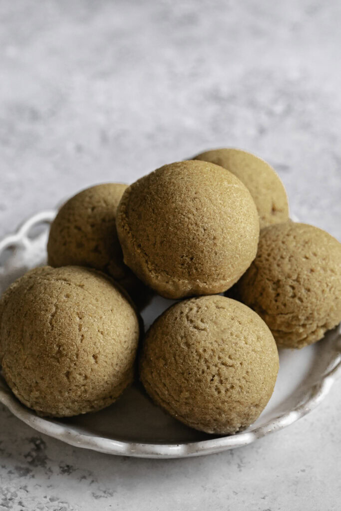 unpowdered donut holes on a small plate.