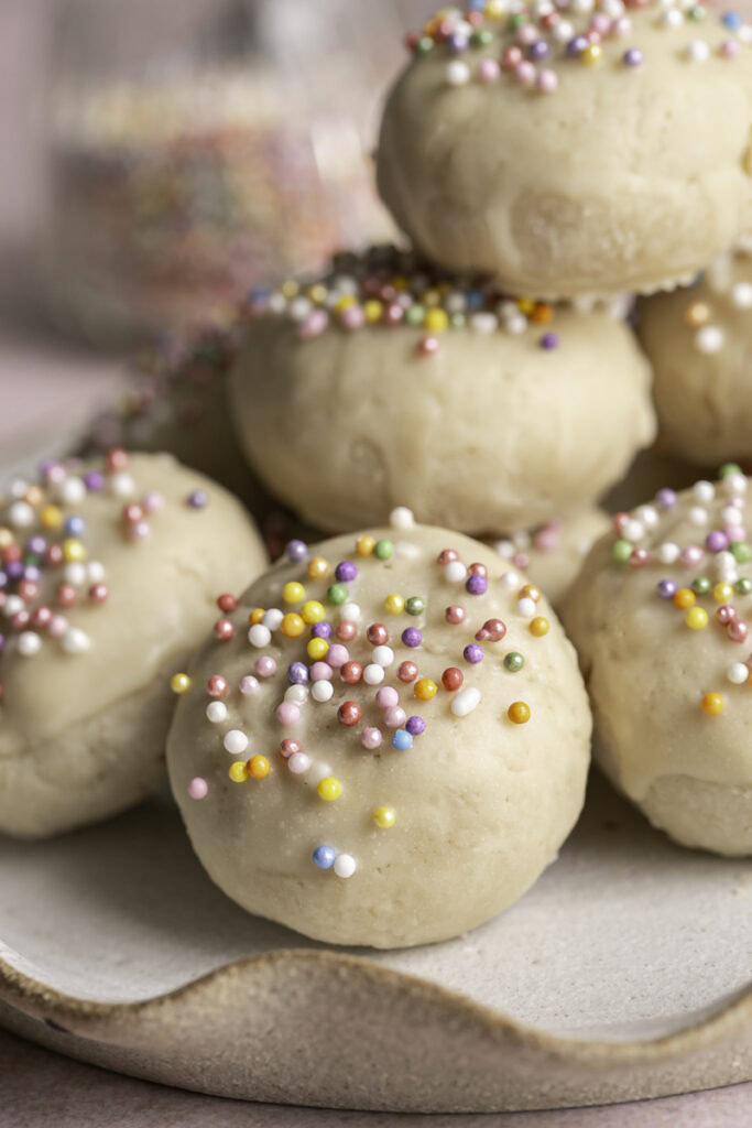 close up of Buttery Soft Italian Sprinkle Biscotti Cookies on a plate.