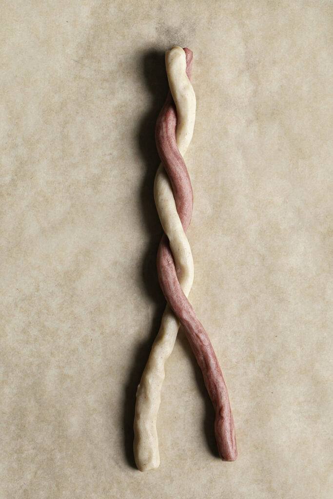 the two strands of red and white cookie dough twisted together.