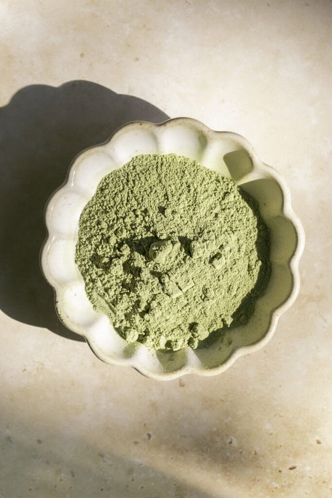 A small bowl of matcha powder.