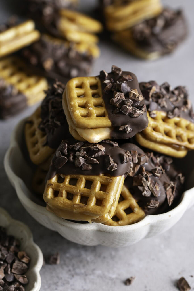 a bowl of Caramel Stuffed Chocolate Dipped Pretzels.