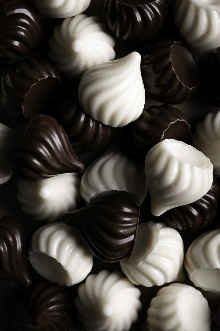 chocolate and white chocolate candy kisses piled on top of one another.