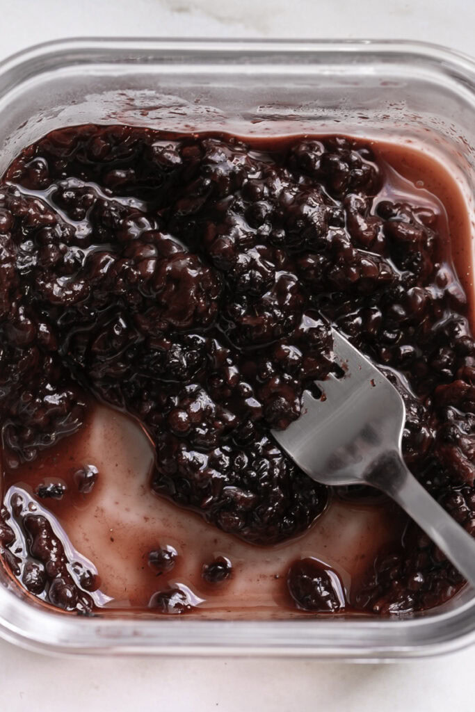 smashed blackberries and a fork.