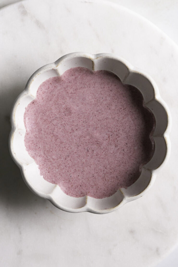 a bowl of melted blackberry white chocolate.