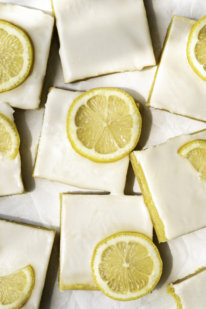 overhead shot of No-Bake Almond Flour Lemon Brownies sliced into squares with slices of fresh lemon.