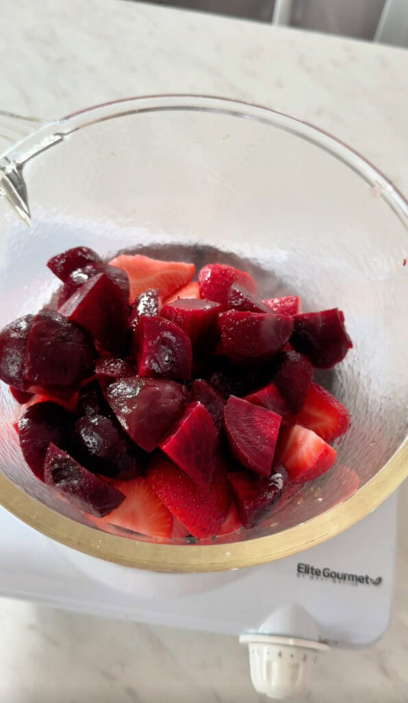 strawberries and beets in a glass saucepan.