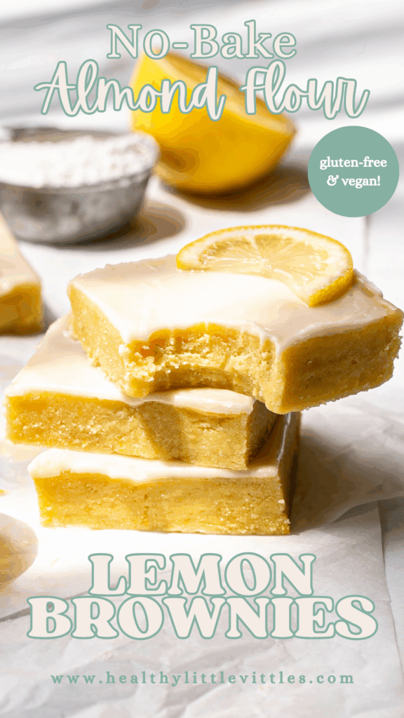 Pinterest graphic of lemon brownies stacked on top of one another, the top slice with a bite taken out of it and No-Bake Almond Flour Lemon Brownies text on the image.