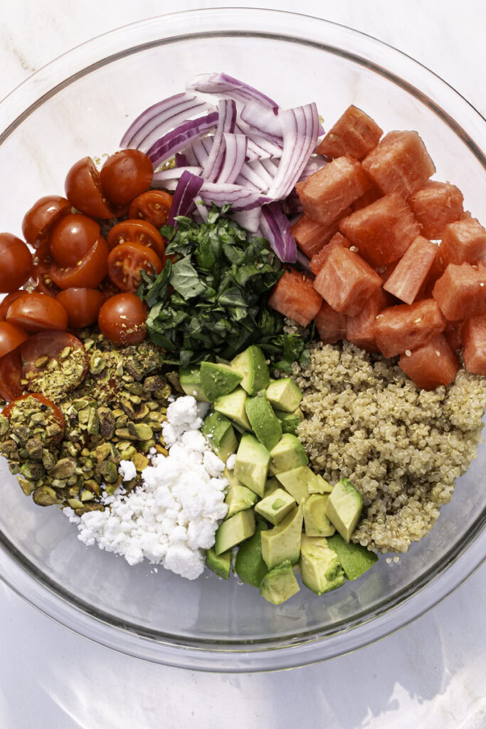all the salad ingredients in a large bowl unmixed.