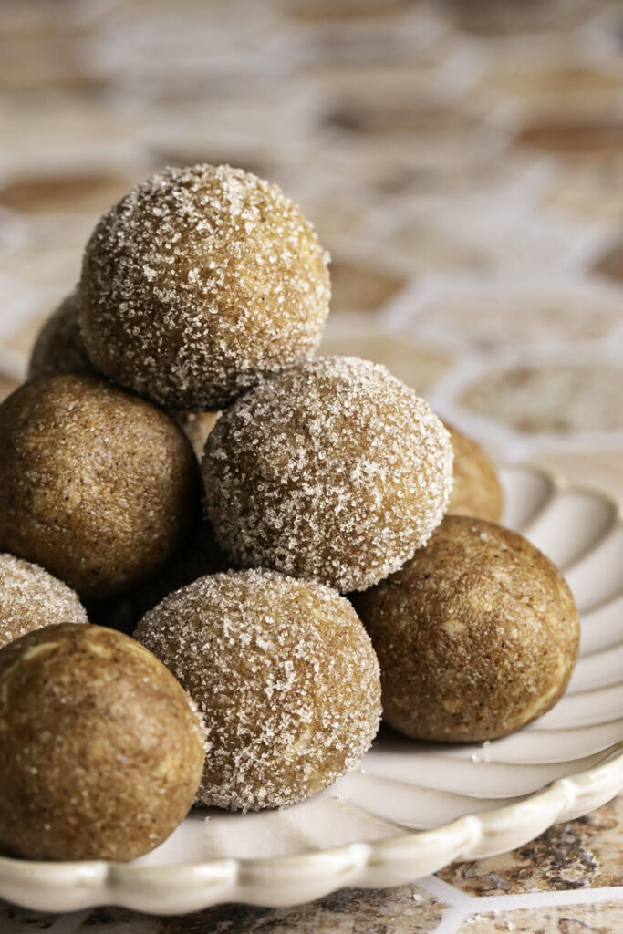 a close up of No-Bake Almond Flour Churro Bites stacked on top of one another.