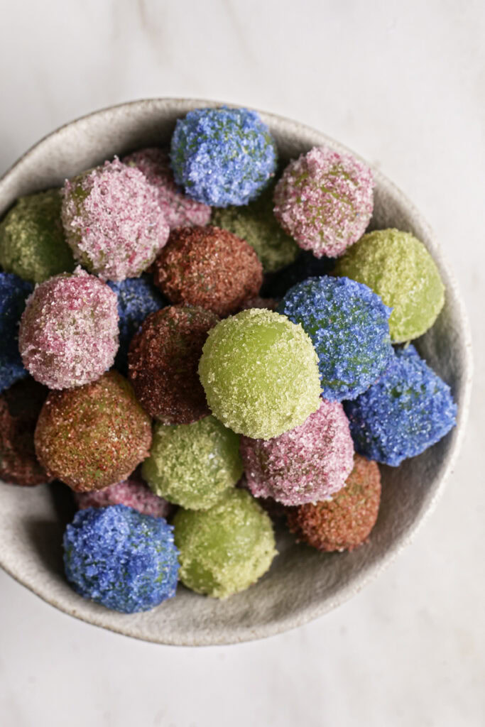 overhead shot of sour patch grapes in a bowl.