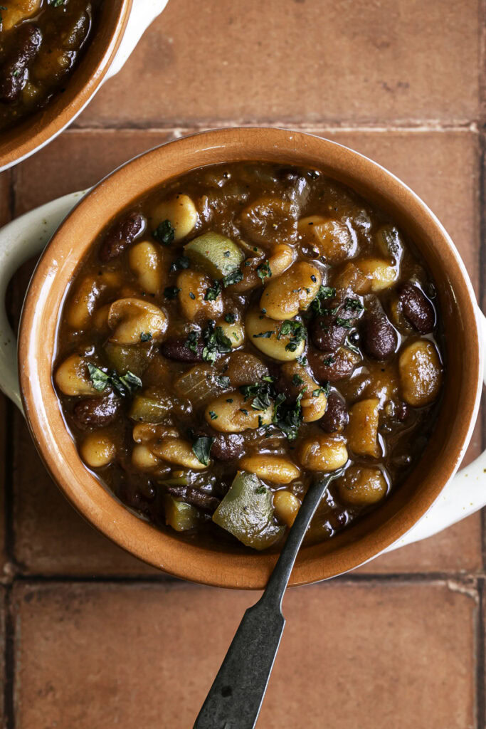 overhead shot of 3 Bean Stovetop Baked Beans with a spoon.