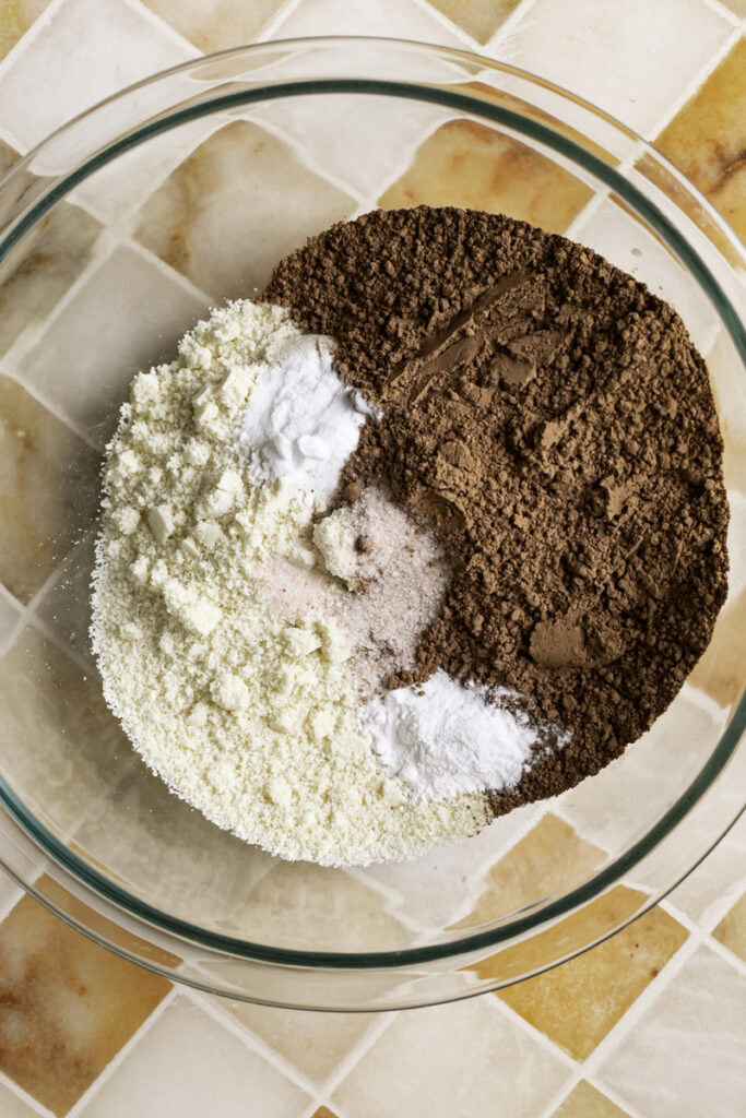 dry brownie ingredients in a glass bowl.