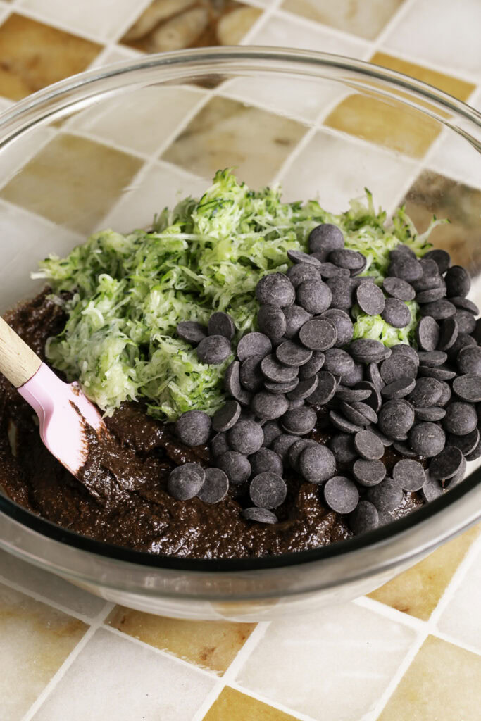shredded zucchini and chocolate chips in the bowl with the brownie batter.