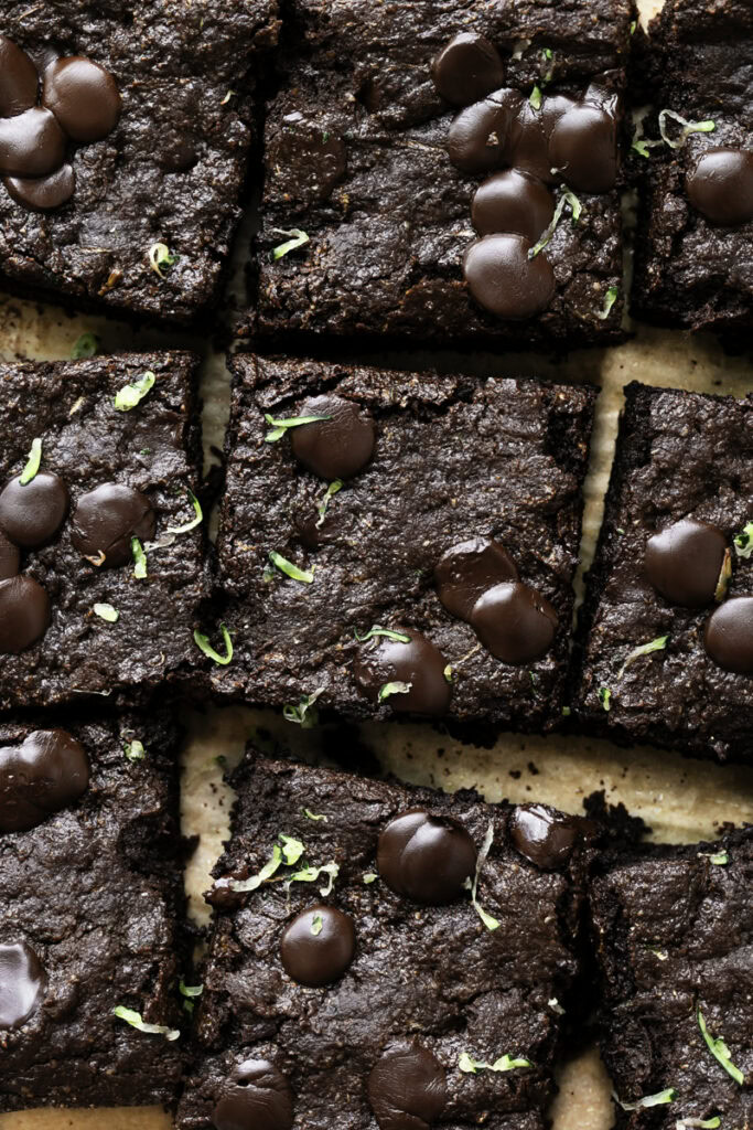 sliced zucchini brownies on a piece of parchment paper.