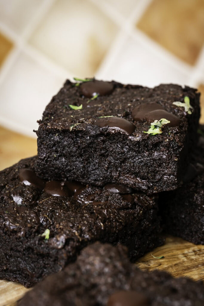 almond flour zucchini tahini brownies stacked on top of one another.