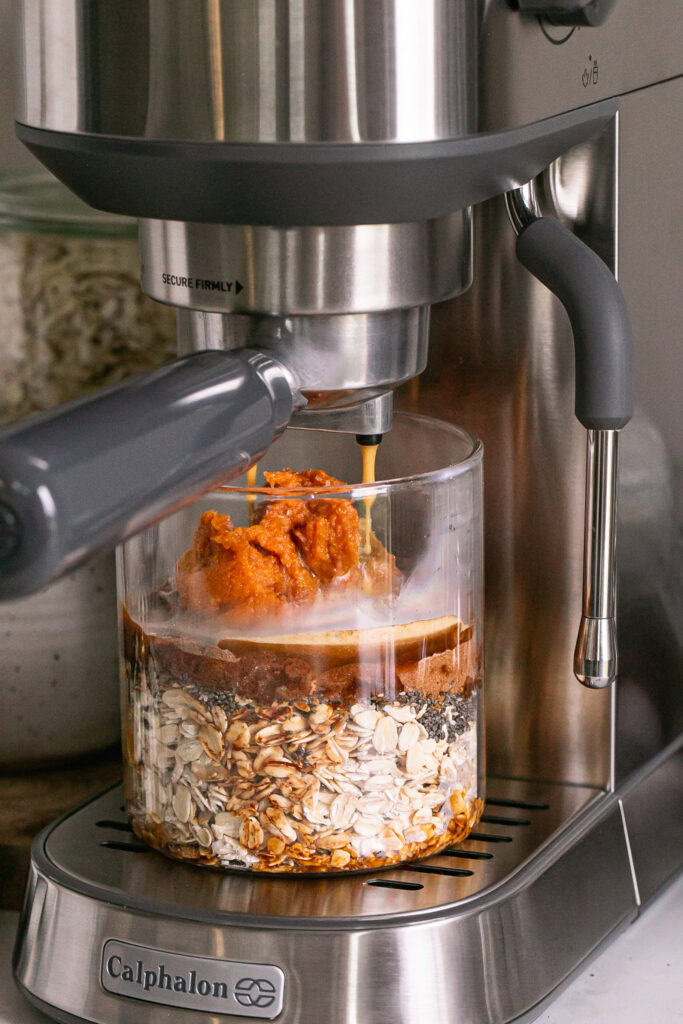 action shot dripping espresso into the glass with the other pumpkin spice espresso overnight oats ingredients.