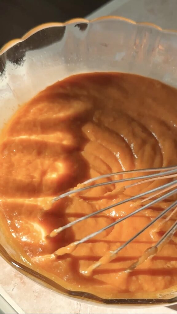 whisking the pumpkin wet ingredients together.