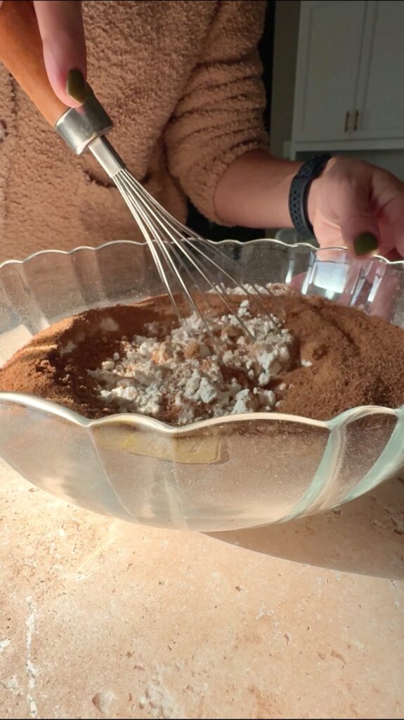 whisking the dry pumpkin cake ingredients together.
