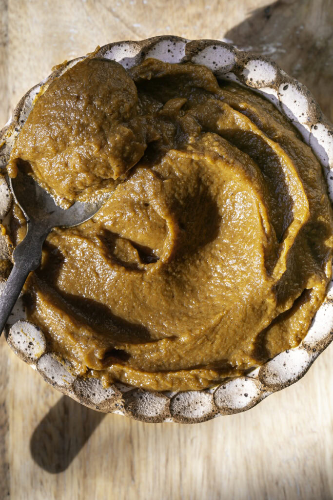 pumpkin butter in a bowl with a spoon.