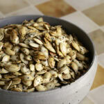 a bowl full of everything bagel roasted pumpkin seeds.